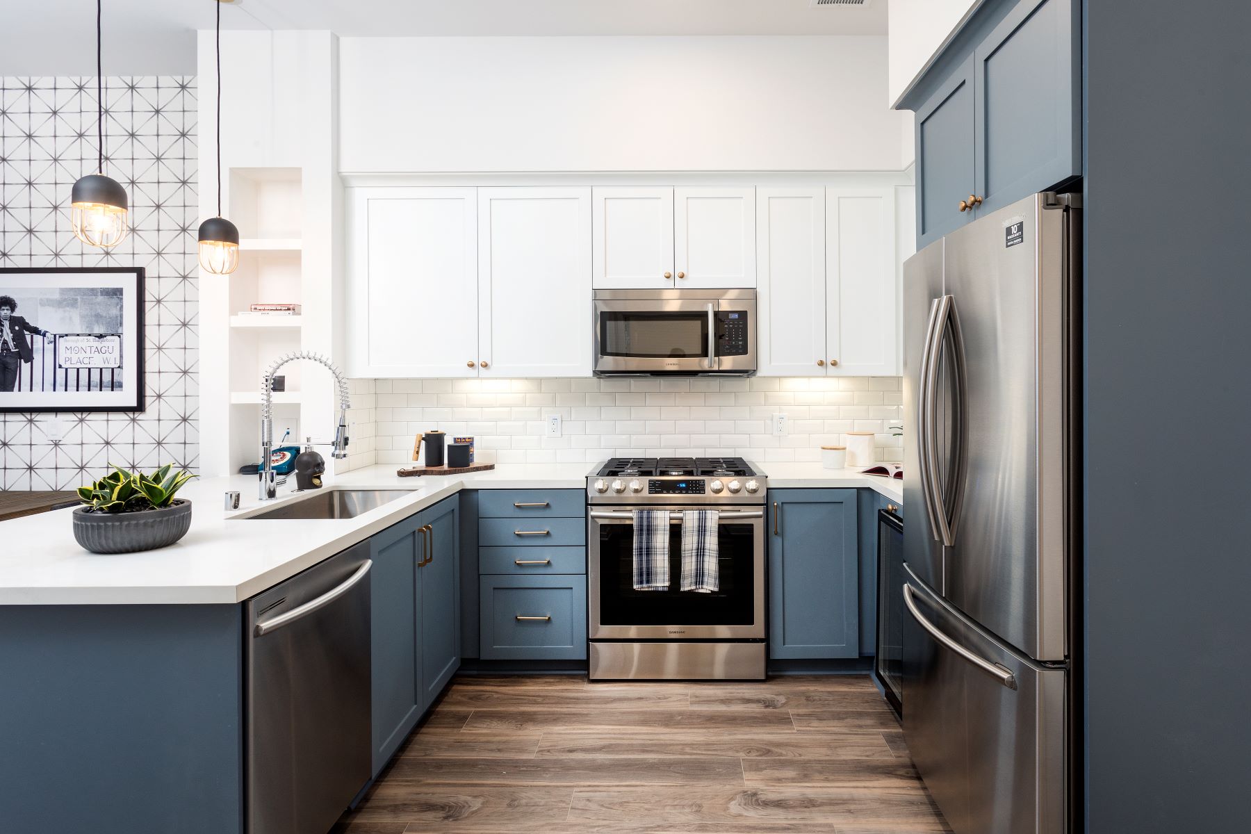 designer white and navy kitchen with gold accents at broadstone arden apartments