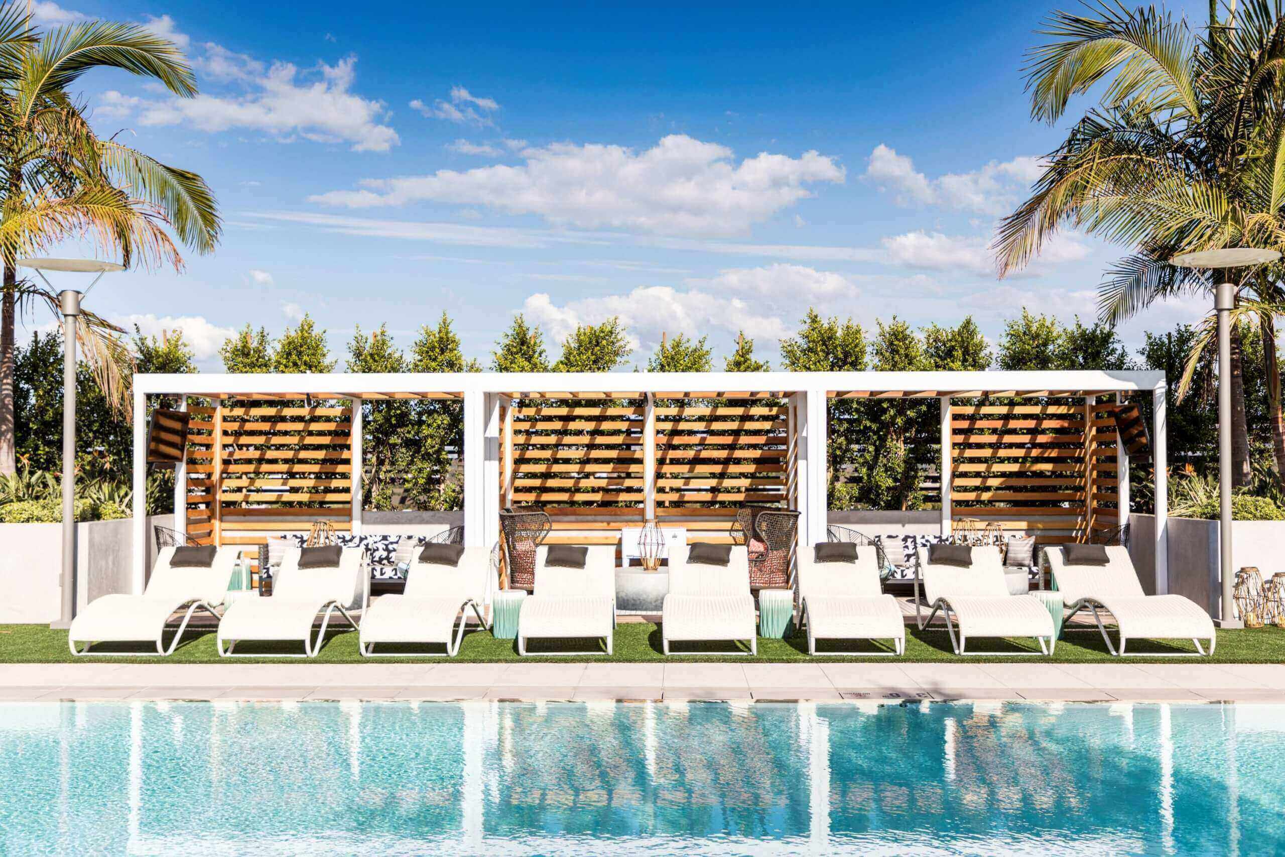 rooftop pool with semi private cabanas and stylish lounge chairs